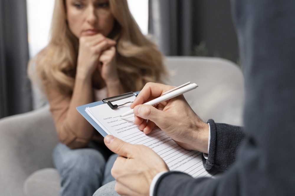 counselor-taking-notes-besides-woman counselor-taking-notes-besides-woman